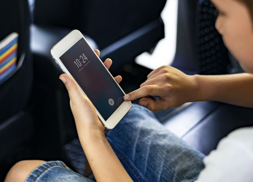 Boy playing on mobile phone.