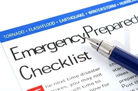 Pen resting on an emergency preparedness checklist. Pen resting on an emergency preparedness checklist.