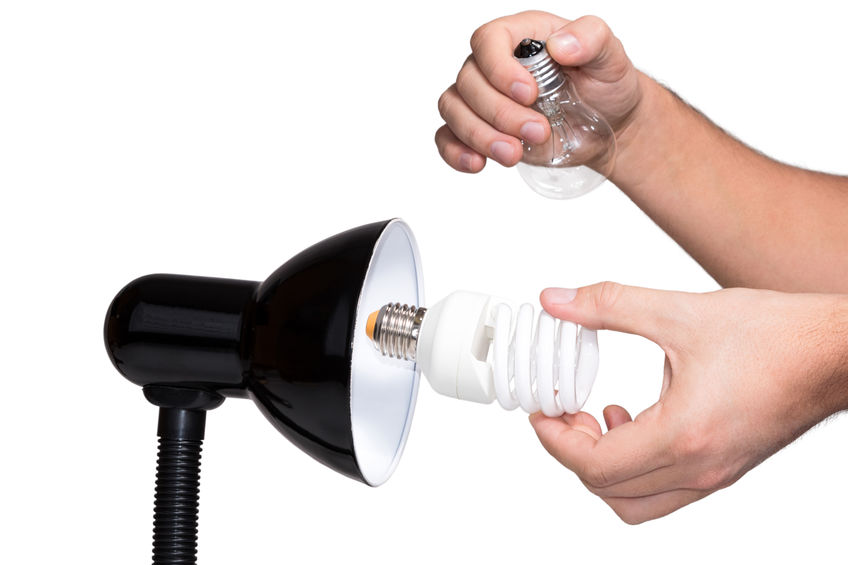 Hand with light bulbs and lamp.