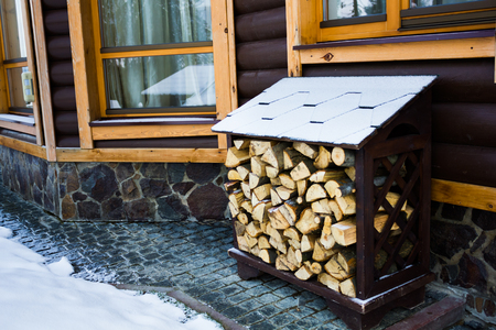 Firewood stacked against home interior.