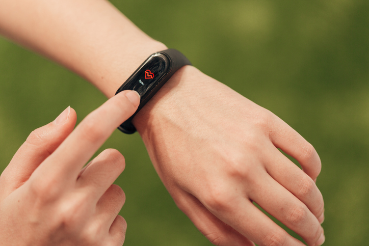 Fitness tracker on woman's wrist.