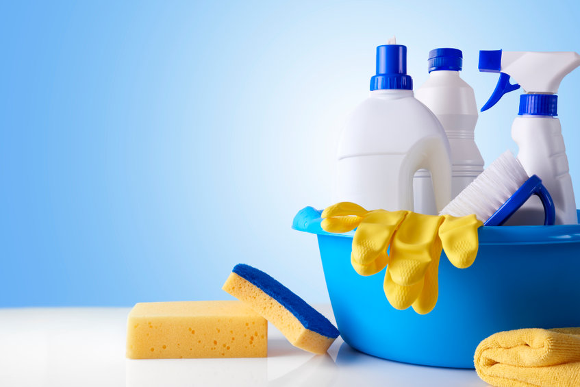 Blue cleaning caddy with products and tools inside.