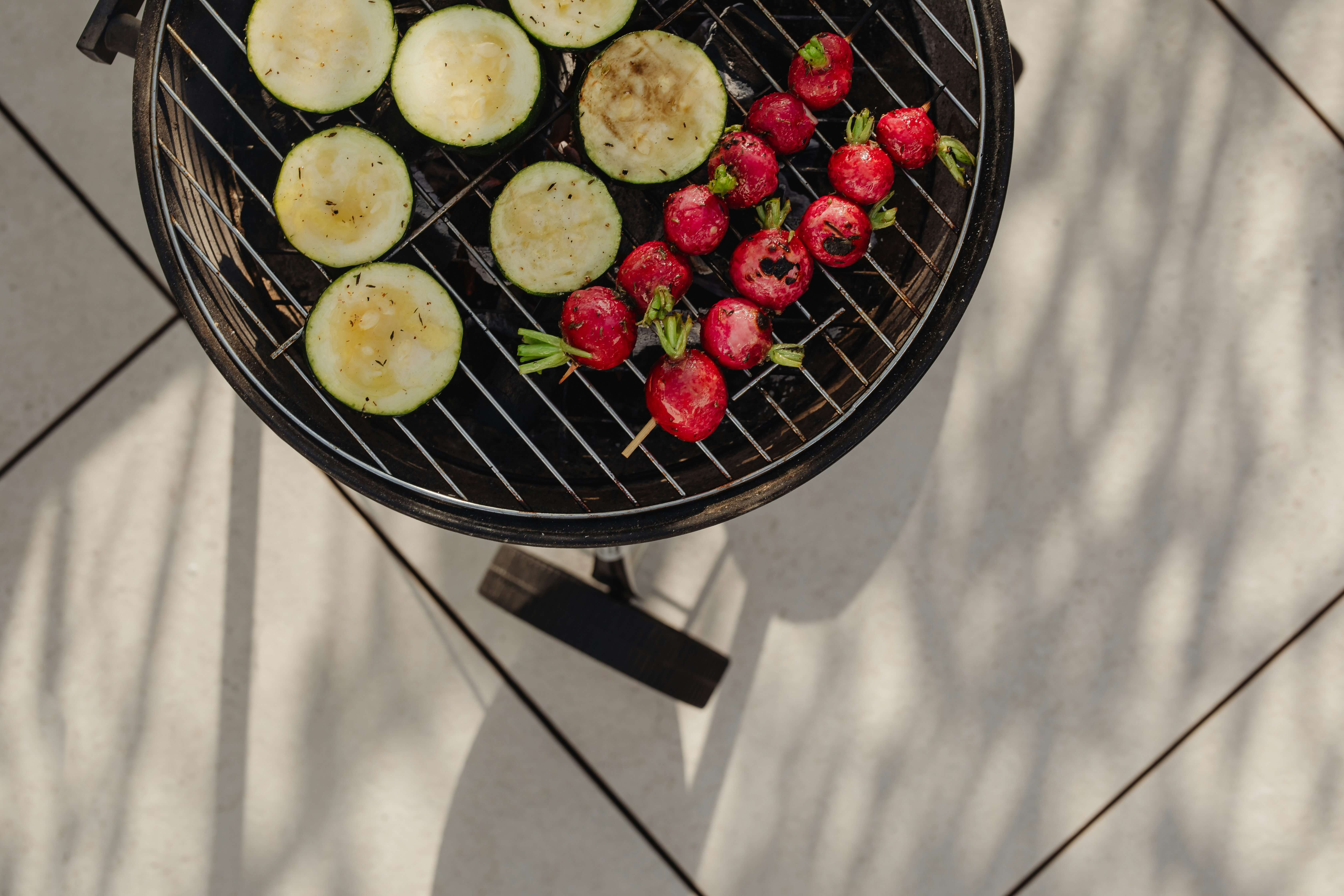 Backyard grill with vegetables on it.