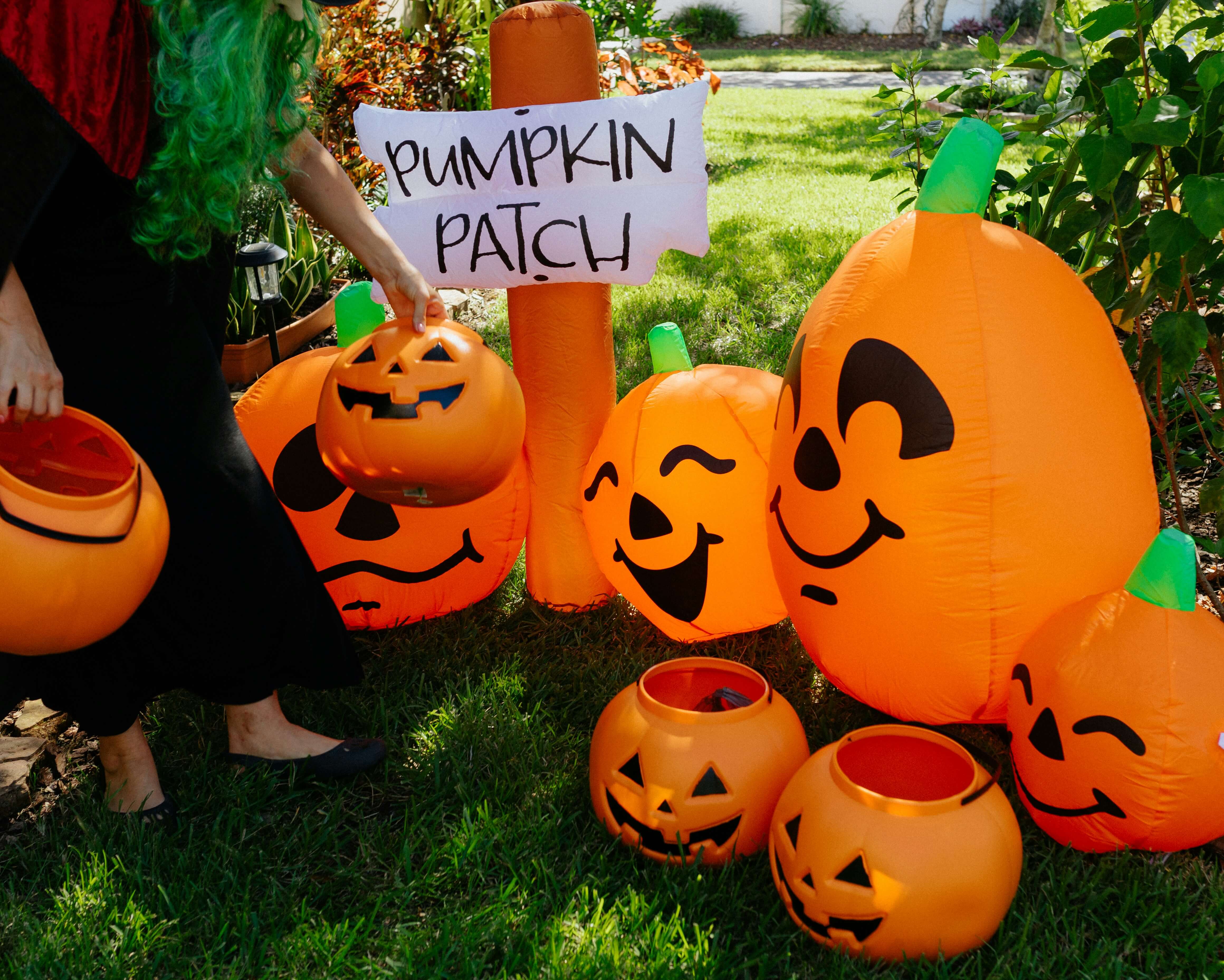 Front yard decorated with blow-up pumpkins.