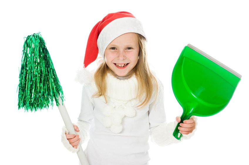 Young girl in Santa Hat with cleaning tools.