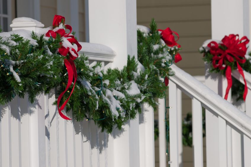 Festive greenery draped on home exterior.