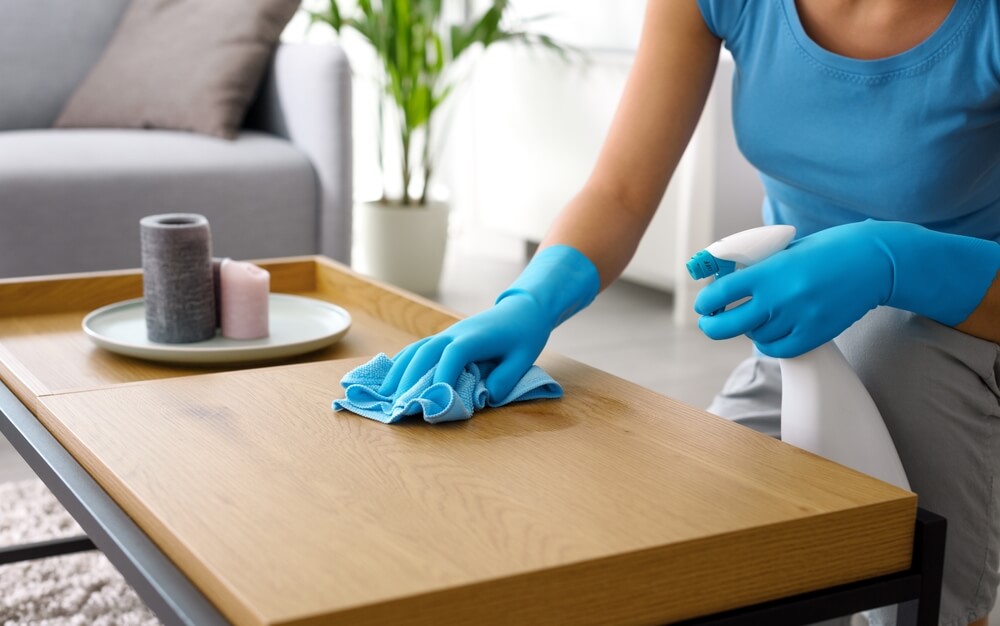 Woman in blue cleaning gloves.