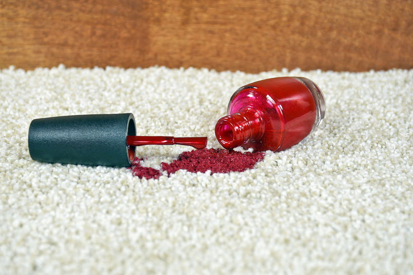 Red nail polished spill on white carpet.
