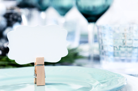 Dinner plate with miniature clothespin and place card.