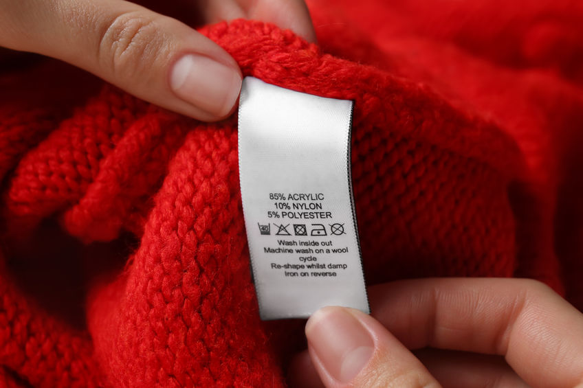 Laundry label on red sweater.