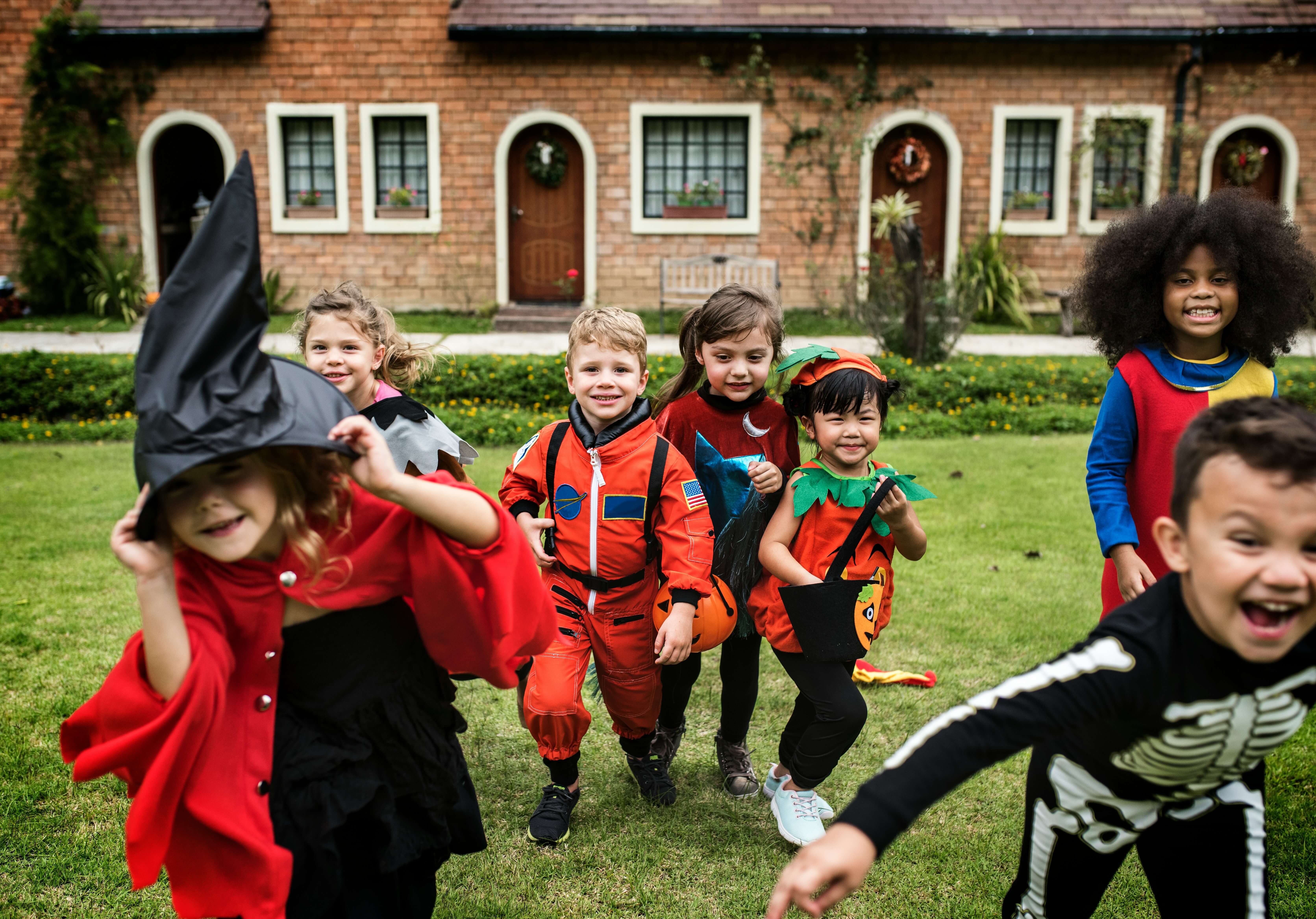 Young costumed kids trick-or-treating.
